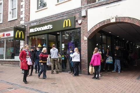 People in queue to enter McDonalds fast food restaurant wearing masks Stock Photos