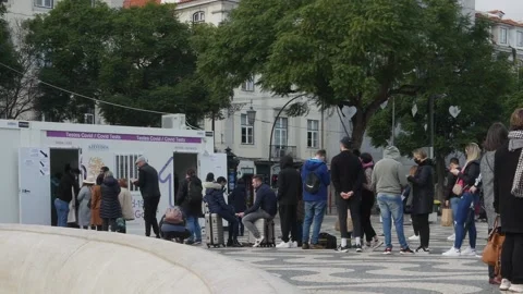 People queue for a free Covid test on Rossio Square in Lisbon, Portugal Stock Footage 167966528