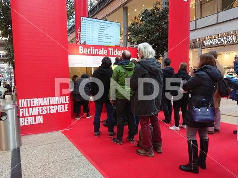 People queue up in front of a booth selling tickets for the Berlinale Festival Stock Photos
