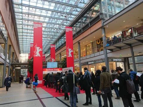 People queue up in front of a booth selling tickets for the Berlinale Festival Stock Photos