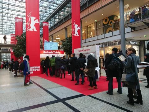 People queue up in front of a booth selling tickets for the Berlinale Festival Stock Photos