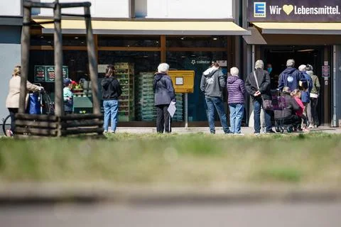 People queue up in front of a supermarket in Berlin, Germany - 06 Apr 2020 Stock Photos
