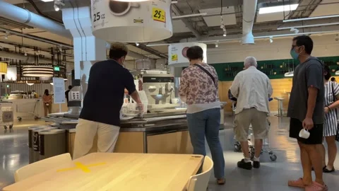 People queue at IKEA restaurant for coffee, tea and hot water at IKEA Store Stock Footage 171668497