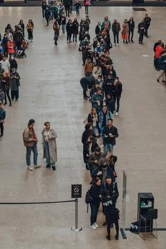 People queue inside Turbine Hall to scan QR codes needed to enter Tate Modern Stock Photos