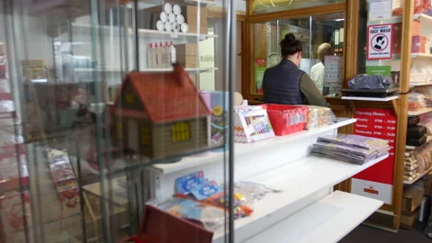 People in a queue line at the post office waiting to mail parcels. Stock Footage 172565709