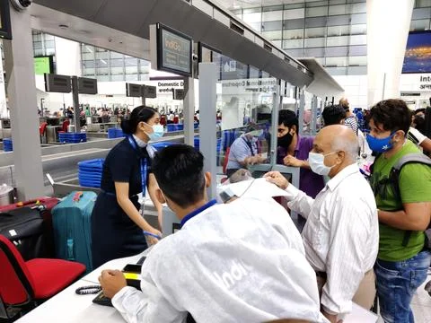 People queue lining up at check in counter in IGI Airport Stock Photos