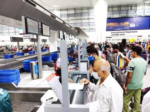 People queue lining up at check in counter in IGI Airport Stock Photos