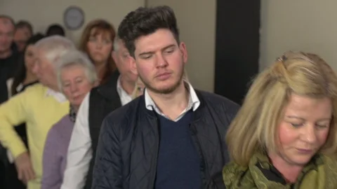 People Queue or Standing in line. Indoors. Queueing up. Waiting. Stock Video Stock Footage 128513963