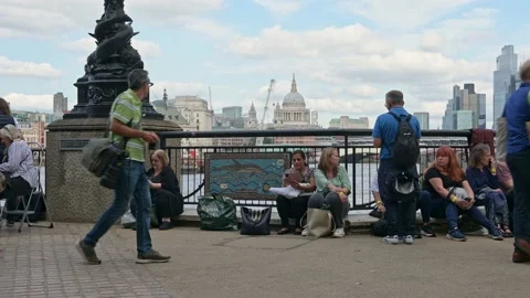 People in The Queue to see the Queen laying in state sit waiting on The Queen Stock Footage 211834121