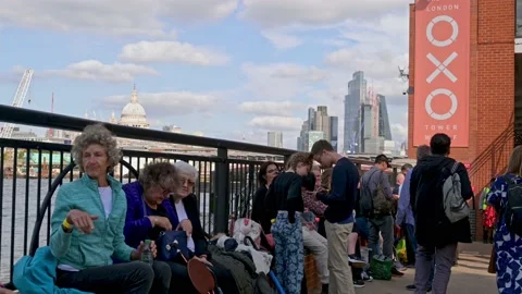 People in The Queue to see the Queen laying in state sit waiting next to Towe Stock Footage 211835288