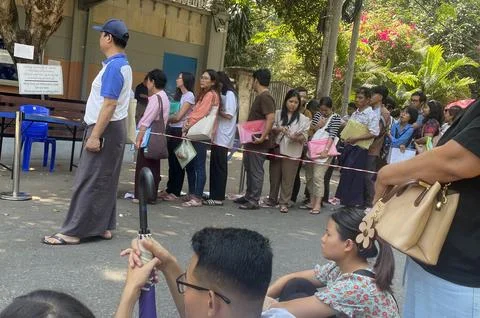 People queue for visas at the Thai embassy in Yangon after military activates co 스톡 사진