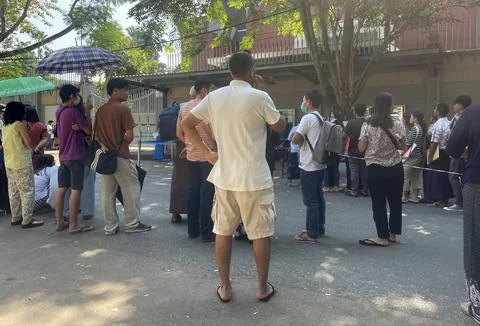 People queue for visas at the Thai embassy in Yangon after military activates co 스톡 사진
