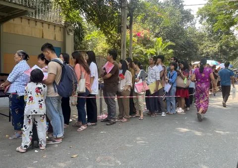 People queue for visas at the Thai embassy in Yangon after military activates co 스톡 사진
