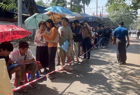 People queue for visas at the Thai embassy in Yangon after military activates co 스톡 사진