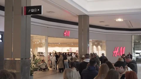 People queue wait to enter popular clothing store during Black Friday. Video stock 247702668