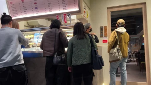People Queueing and Ordering at a Busy Modern Deli Food Counter 스톡 동영상 335263426
