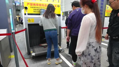 People queueing for baggage security check at a Chinese train station Stock Footage 334699394