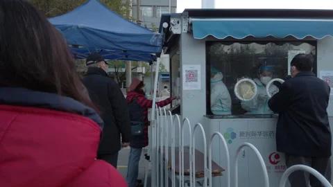 People queueing for covid test on street, Beijing, China. Stock Footage 225671114
