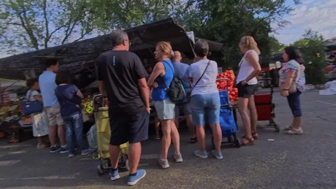 People Queueing at Outdoor Fruit and Vegetable Market Stall Stock Footage 345898649