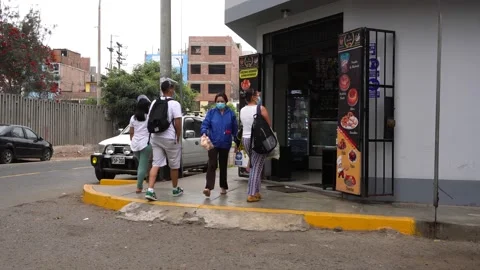 People queuing at a bakery wearing a mask and face shield Stock Footage 148339659