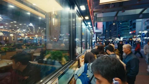 People Queuing in Front of a Cha Chaan Teng Hong Kong-style Cafe Diner in Stockbeeldmateriaal 332639755