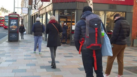 People queuing outside a coffee shop practicing social distancing in pandemic. Stock Footage 146500801