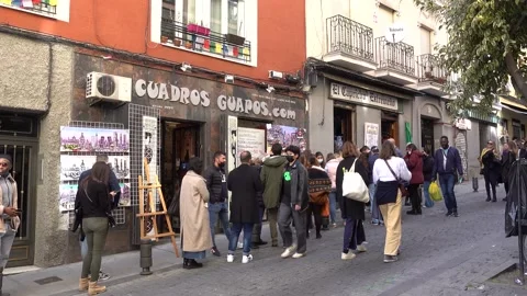 People queuing up in the street to get served in a restaurant in Madrid Stock Footage