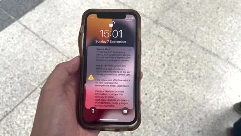 People react to a test of the national emergency alert system  Stock Footage 316539940