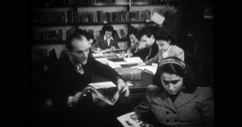 People reading in U.S. Information Agency office Stock Footage