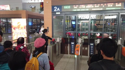 People ready to board the train at the Kunming South Train Station Stock Footage 121743074