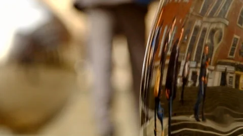 People reflected in chrome metal sphere 2 Stock Footage 36568508