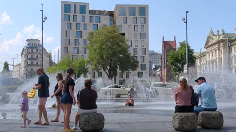 People refresh themselves at the Stachusbrunnen in Munich Stock Footage 342340074