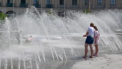 People refresh themselves at the Stachusbrunnen in Munich Stock Footage 342340669