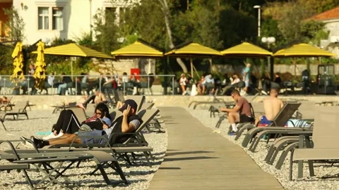 People relax on the beach Stockbeeldmateriaal 97813486