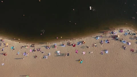 People relax on the beach by the river Stock Footage 263296503
