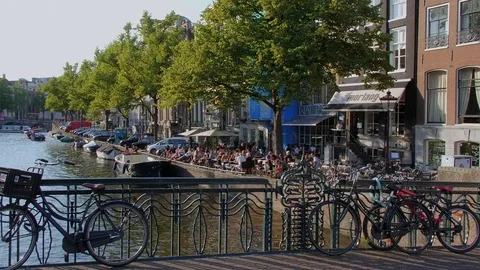 People relax at the canals of Amsterdam - a beautiful place Stock Footage