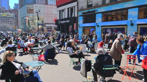People relax at Macy's Herald Square on Sunday afternoon in New York City Stock Footage 241839207