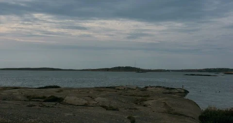 People relaxing on cliffs and bathing on an island in the swedish archipelago Видео 94979747