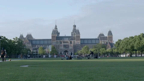 People Relaxing on Museumplein Lawn in Front of Rijksmuseum Stock Footage 343980222
