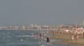 People relaxing walking on the sandy beach Rimini Italy summer holiday cityscape HD Footage