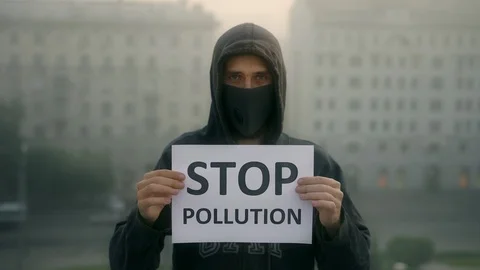 People in respiratory look at camera backdrop city fog banner stop pollution 4K Video stock 114990945