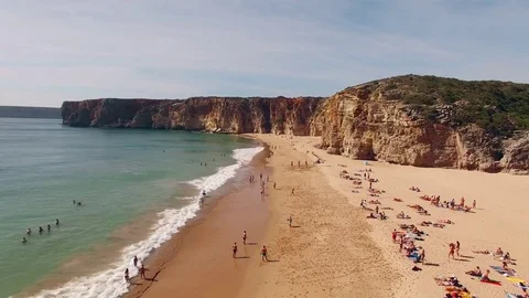 People rest on a beautiful sandy beach in Portugal, Praia do Beliche, Sagres Stock Footage 81120975
