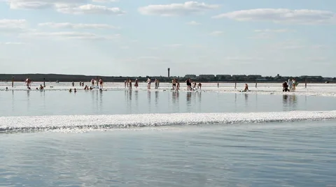 People rest at the exotic salt lake Baskunchak Stock Footage