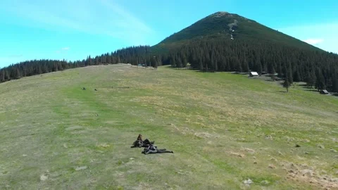 People rest on mountain meadow Stock Footage 157939707