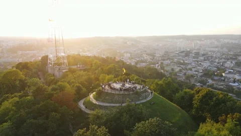 People rest on the top of the mountain overlooking the city view at sunset Stock Footage 162493719