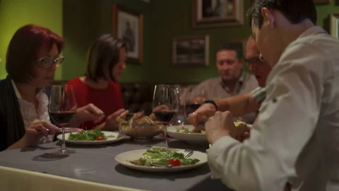 People in the restaurant, sitting at a table talking and eating Stock Footage 91314049