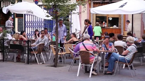 People in a restaurant terrace in the plaza mayor in madrid spain Stock Footage