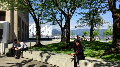 People resting and reading mobile message in downtown Vancouver BC Canada. Stock Footage 63818381
