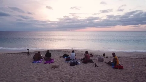 People Resting on the Beach During Sunset Stock Footage 117353625