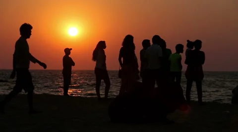 People resting on the beach at sunset Stock Footage 59934202
